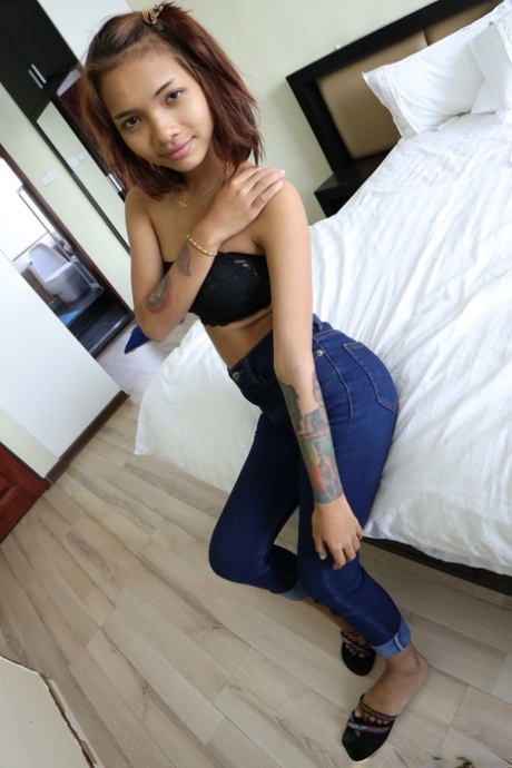Pretty Asian girl Emelyn shows off her petite body while undressing for sex