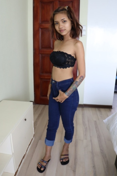Pretty Asian girl Emelyn shows off her petite body while undressing for sex